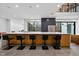 Open concept kitchen island with barstool seating and view of modern kitchen appliances at 4908 Birchleaf Dr, Raleigh, NC 27606