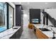 View of the modern kitchen with a quartz countertop island, adjacent to pool area, stairs, and living room at 4908 Birchleaf Dr, Raleigh, NC 27606
