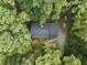 Aerial view of house surrounded by lush green trees, driveway, and landscaping at 5125 Penny Rd, Raleigh, NC 27606