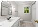 Bright bathroom featuring a window, single vanity, and shower with curtain at 5125 Penny Rd, Raleigh, NC 27606