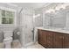 Elegant bathroom with a glass-enclosed shower, marble accents, and a double vanity at 5125 Penny Rd, Raleigh, NC 27606