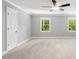 Bright bedroom with neutral walls, carpeted flooring, and two windows that enhance the space at 5125 Penny Rd, Raleigh, NC 27606