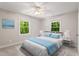 Bright bedroom with large windows, neutral decor, and a comfortable bed with blue accents at 5125 Penny Rd, Raleigh, NC 27606