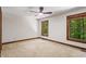 Bedroom with carpet and windows with views of the surrounding trees at 5125 Penny Rd, Raleigh, NC 27606