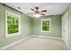Cozy bedroom featuring a ceiling fan, neutral carpet, and a bright window at 5125 Penny Rd, Raleigh, NC 27606