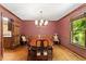 Formal dining room with wood floors, chandelier lighting, and traditional decor at 5125 Penny Rd, Raleigh, NC 27606