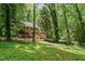 Traditional two-story brick home with a well-manicured lawn and lush trees providing privacy and curb appeal at 5125 Penny Rd, Raleigh, NC 27606