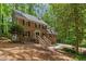 Exterior of a two-story brick home with a manicured lawn, mature trees, and a welcoming entrance staircase at 5125 Penny Rd, Raleigh, NC 27606
