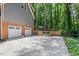Two-car garage with updated gray siding and a fenced-in yard, offering both convenience and curb appeal at 5125 Penny Rd, Raleigh, NC 27606