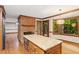 Bright kitchen featuring an island with granite countertops, natural light, and stainless appliances at 5125 Penny Rd, Raleigh, NC 27606