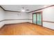 Spacious living room with gleaming hardwood floors and a large door with access to porch at 5125 Penny Rd, Raleigh, NC 27606
