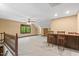 Large living room featuring a wet bar, neutral carpeting, and natural light at 5125 Penny Rd, Raleigh, NC 27606