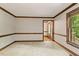 Living room with hardwood trim and doorway to the front door at 5125 Penny Rd, Raleigh, NC 27606