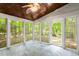 A sunroom featuring multiple windows and a decorative ceiling fan at 5125 Penny Rd, Raleigh, NC 27606