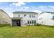 View of the home's backyard, showing the lawn, screened porch, and exterior siding at 5420 Mill Dam Rd, Wake Forest, NC 27587