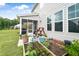 Home's backyard with screened in porch, lovely landscaping, raised garden, and green grass at 5420 Mill Dam Rd, Wake Forest, NC 27587
