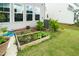 The backyard offers a garden bed, healthy green plants, and a lush lawn at 5420 Mill Dam Rd, Wake Forest, NC 27587