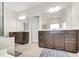 Bathroom with double vanity, dark cabinets, large mirrors, and tile flooring at 5420 Mill Dam Rd, Wake Forest, NC 27587