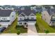 Stunning aerial view of a two-story home with a well-manicured lawn, and a spacious driveway at 5420 Mill Dam Rd, Wake Forest, NC 27587
