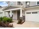 The home has a welcoming front porch with stone columns, and a two-car garage at 5420 Mill Dam Rd, Wake Forest, NC 27587