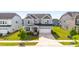 Charming two-story home with a manicured front lawn and attached two car garage at 5420 Mill Dam Rd, Wake Forest, NC 27587