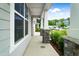 Inviting front porch with stone accents and ample space for outdoor seating overlooking the landscaped front yard at 5420 Mill Dam Rd, Wake Forest, NC 27587