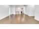 Bright hallway featuring hardwood floors, white trim and doors, and a staircase leading to the next level at 5420 Mill Dam Rd, Wake Forest, NC 27587