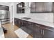 Modern kitchen showcasing dark cabinets, granite countertops, stainless steel appliances, and hardwood floors at 5420 Mill Dam Rd, Wake Forest, NC 27587
