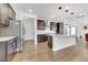 Open kitchen boasts stainless appliances, dark cabinets, light countertops, and modern pendant lighting at 5420 Mill Dam Rd, Wake Forest, NC 27587
