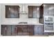 Modern kitchen showcasing dark cabinets, granite countertops, stainless steel appliances, and designer backsplash at 5420 Mill Dam Rd, Wake Forest, NC 27587