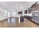 Open concept living featuring a modern kitchen with stainless appliances, an island, and hardwood floors at 5420 Mill Dam Rd, Wake Forest, NC 27587