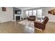 Bright living room featuring a cozy fireplace, hardwood floors, and modern decor with windows at 5420 Mill Dam Rd, Wake Forest, NC 27587