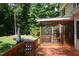Back deck with hot tub, screened porch, and view of the backyard, perfect for relaxation and entertaining at 5917 Clearsprings Dr, Wake Forest, NC 27587