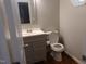 Charming powder room featuring hardwood floors, modern vanity and updated toilet at 5917 Clearsprings Dr, Wake Forest, NC 27587
