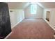 Spacious bonus room with large window, neutral walls, and cozy carpet at 5917 Clearsprings Dr, Wake Forest, NC 27587