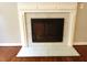 Close-up of the white marble fireplace, hardwood floors, and contemporary design that adds warmth to the home at 5917 Clearsprings Dr, Wake Forest, NC 27587