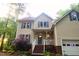 Beautiful two-story home featuring a welcoming front porch, tasteful landscaping, and attached garage, a warm curb appeal at 5917 Clearsprings Dr, Wake Forest, NC 27587