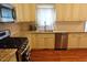 Well-equipped kitchen with stainless steel appliances, granite countertops, white cabinetry, and hardwood floors at 5917 Clearsprings Dr, Wake Forest, NC 27587