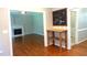Spacious living area with hardwood floors, a white fireplace, and open entryway that leads to the rest of the home at 5917 Clearsprings Dr, Wake Forest, NC 27587