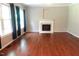 Bright living room showcasing hardwood floors, a cozy fireplace, and large windows offering natural light and style at 5917 Clearsprings Dr, Wake Forest, NC 27587