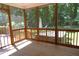 View from a screened porch to the backyard, lush greenery, swing set, and hot tub at 5917 Clearsprings Dr, Wake Forest, NC 27587