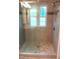Modern shower features glass door, tile surround, and shower head at 5917 Clearsprings Dr, Wake Forest, NC 27587