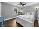 Bedroom featuring a cozy bed, dark floors, and a view of the outdoor scenery at 6 Weathergreen Ct, Durham, NC 27713