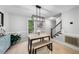 Bright dining area featuring modern light fixture, wooden table with bench, and neutral decor at 6 Weathergreen Ct, Durham, NC 27713