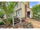 Exterior view of the home showcasing its back entrance, staircase, and brick accents at 6 Weathergreen Ct, Durham, NC 27713