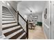 Welcoming foyer with wooden stairs, dining area, and neutral wall paint throughout at 6 Weathergreen Ct, Durham, NC 27713