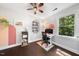 Bright home office with ceiling fan, dark floors, and a modern desk at 6 Weathergreen Ct, Durham, NC 27713