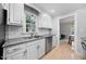 Bright kitchen with white cabinets, stainless appliances, and a view of the backyard at 6 Weathergreen Ct, Durham, NC 27713