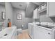 Functional laundry room with washer, dryer, and storage cabinets in a neutral color palette at 6 Weathergreen Ct, Durham, NC 27713