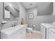 Bright laundry room featuring washer, dryer, sink, and upper cabinets in a modern style at 6 Weathergreen Ct, Durham, NC 27713